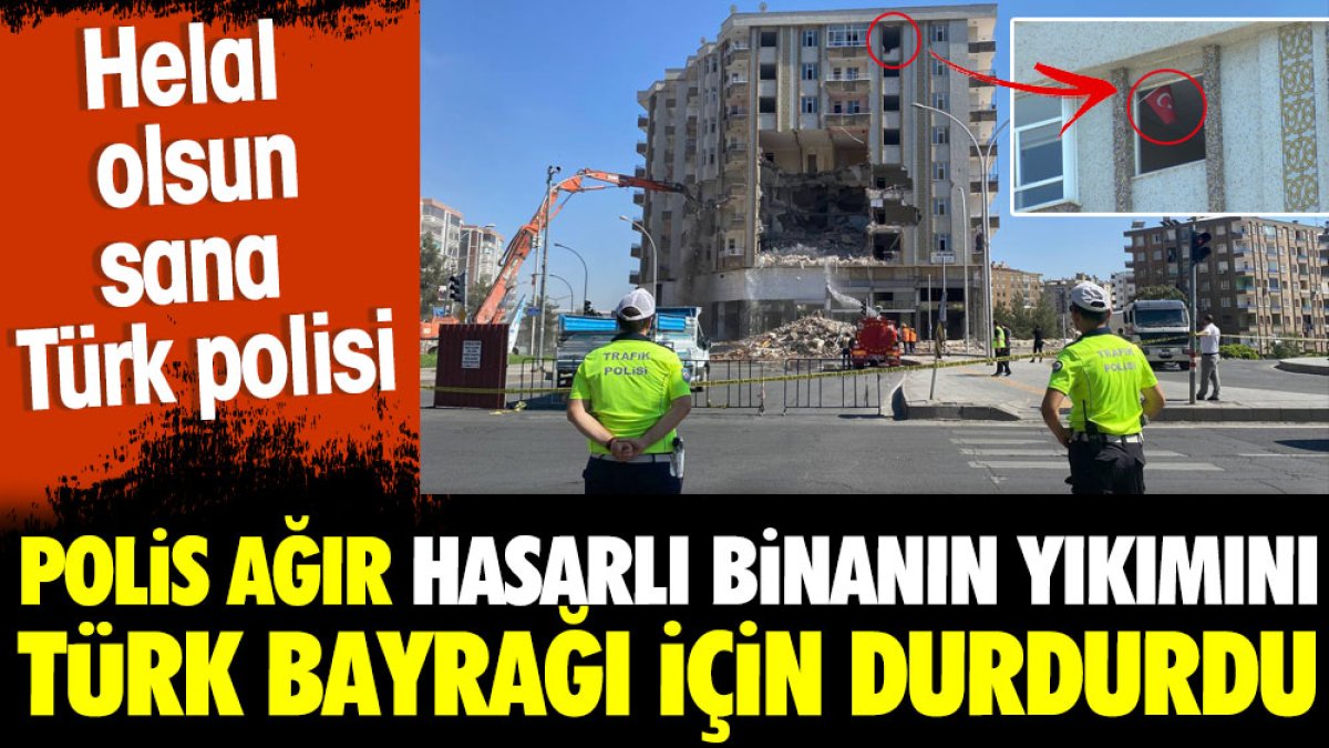 Polis ağır hasarlı binanın yıkımını Türk bayrağı için durdurdu