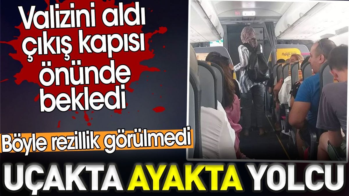 Uçakta ayakta yolcu. Valizini aldı çıkış kapısı önünde bekledi