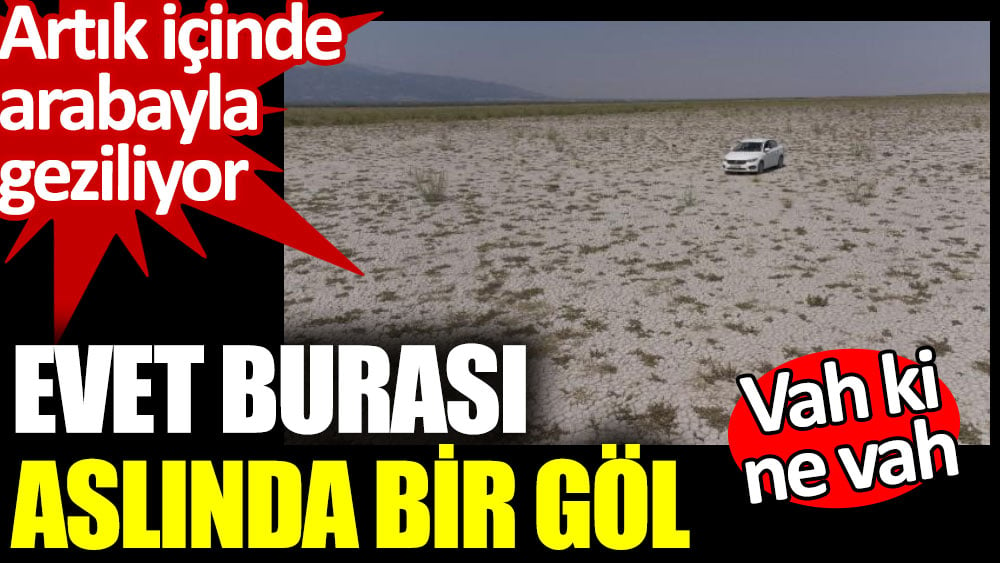 Kuruyan gölün içinde arabayla geziliyor