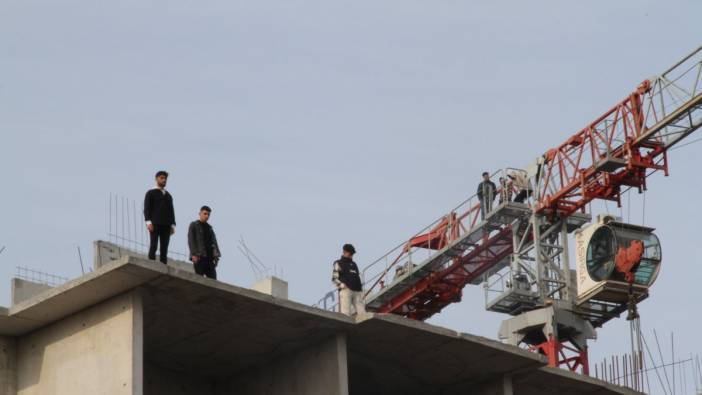 İşçiler emeğinin karşılığına alamayınca kendi diktikleri binanın tepesinde intihara kalkıştılar