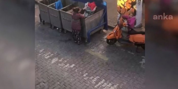 Genç kadın çocuğuyla birlikte çöp konteynerinden çürümüş sebze topluyor. Buz gibi gerçek