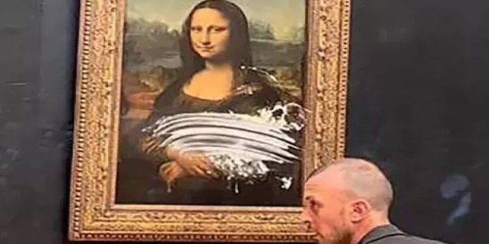 Mona Lisa'nın ne suç var. Peruk takıp, ruj süren adam ünlü tabloya pasta fırlattı