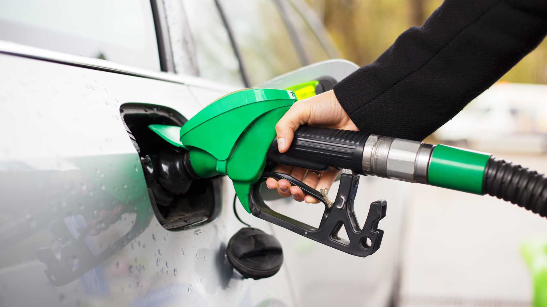 hand-holding-fuel-pump-and-refilling-car-at-petrol-station.jpg