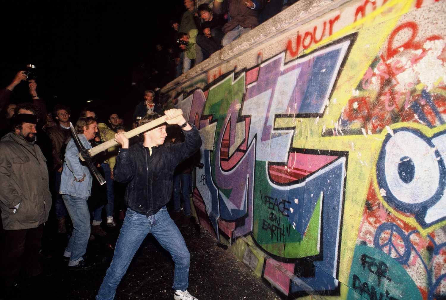 a-man-attacks-the-berlin-wall-with-a-pickaxe-on-the-night-of-november-9th-1989-527012766-594758705f9b58d58ae778c6.jpg