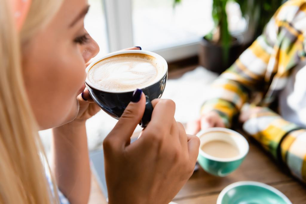 stock-photo-cropped-view-woman-drinking-coffee.jpg