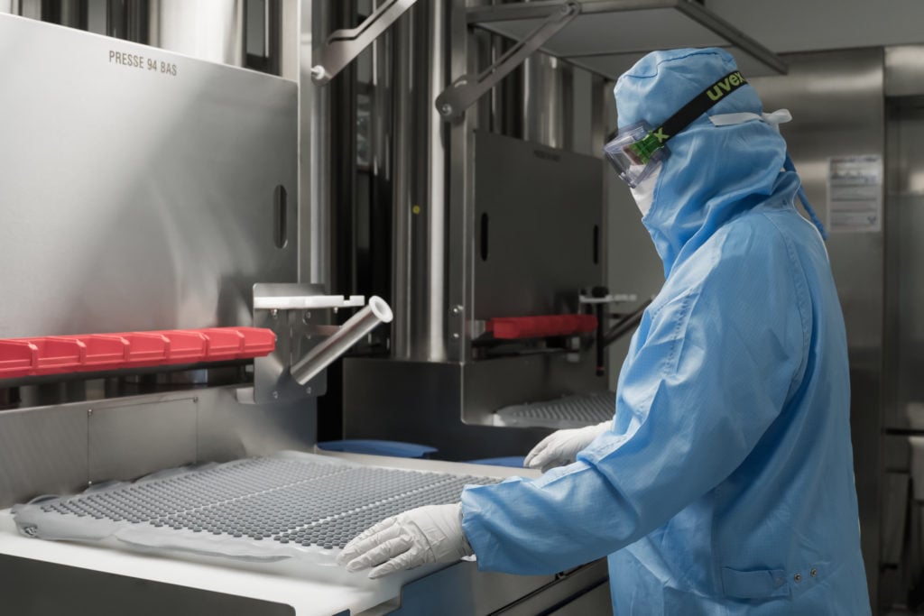 operator-working-in-a-clean-room-with-rubber-vial-stoppers-1024x683.jpg