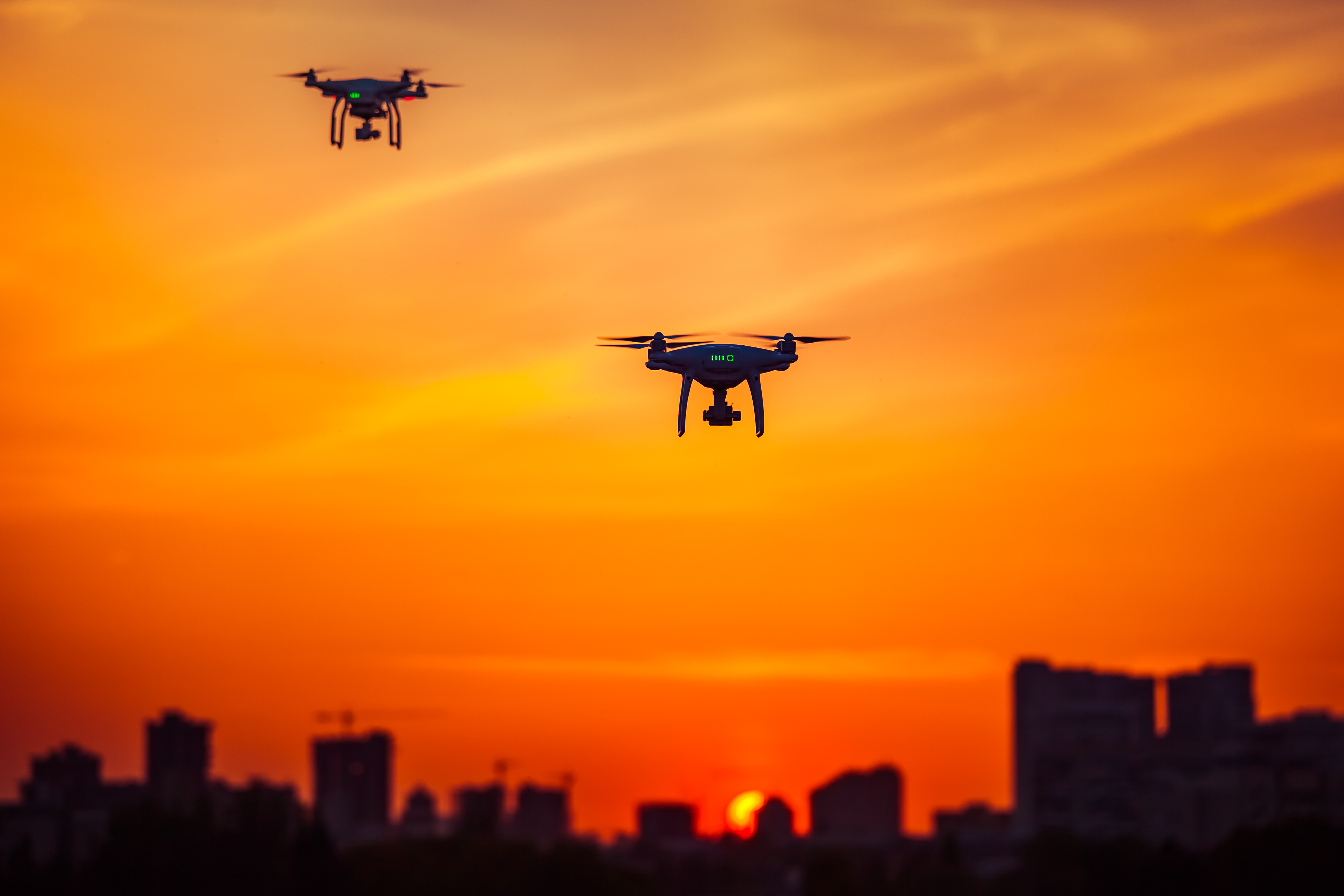 two-modern-remote-control-air-drones-fly-with-acti-2023-11-27-05-10-37-utc.jpg